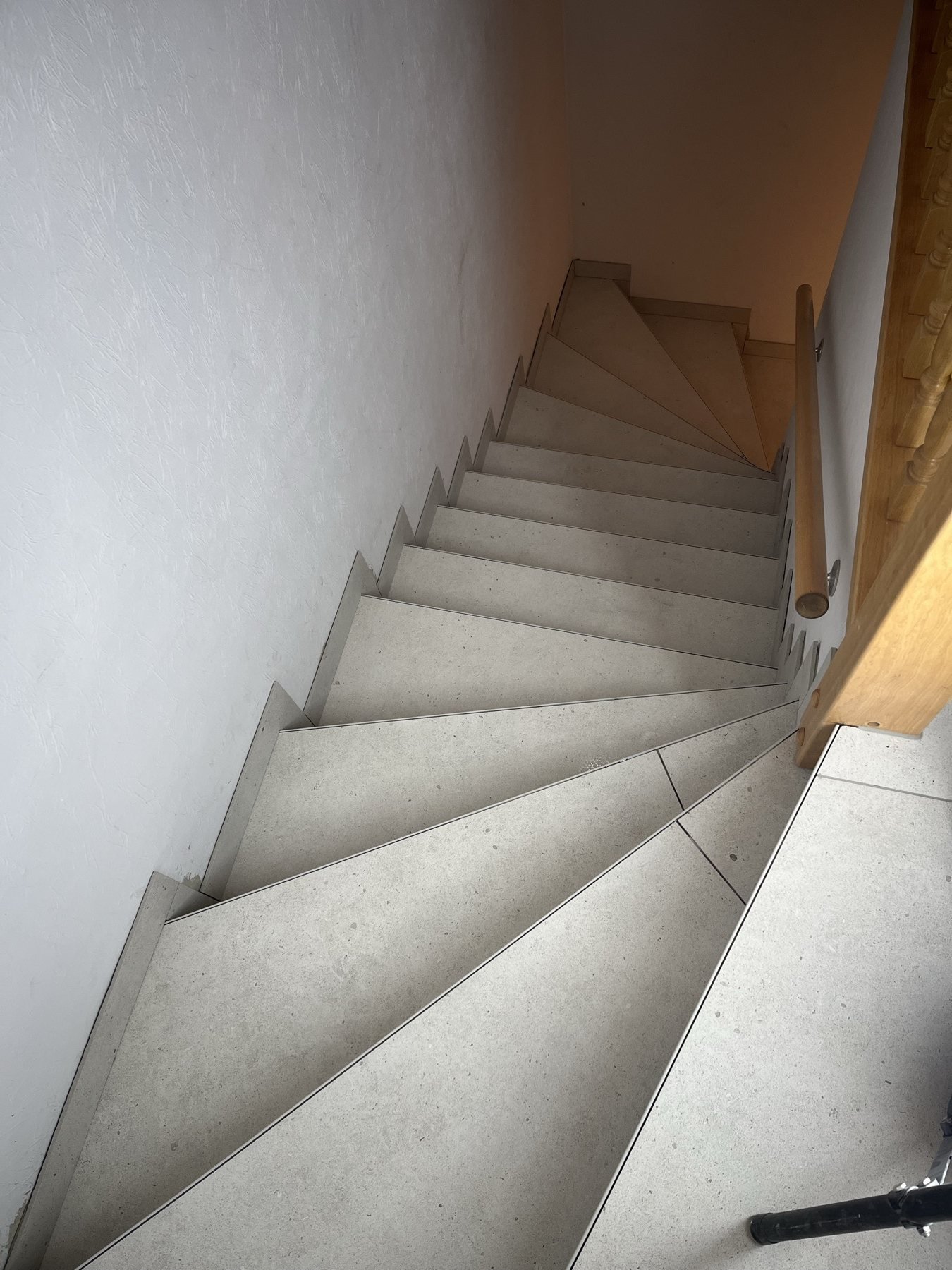 Heller Fliesenbelag auf einer gewendelten Treppe